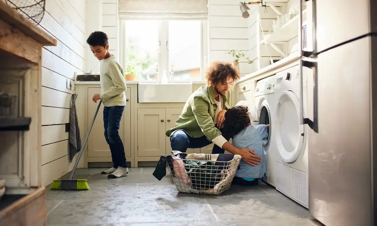 Family cleaning laundry room as part of spring cleaning